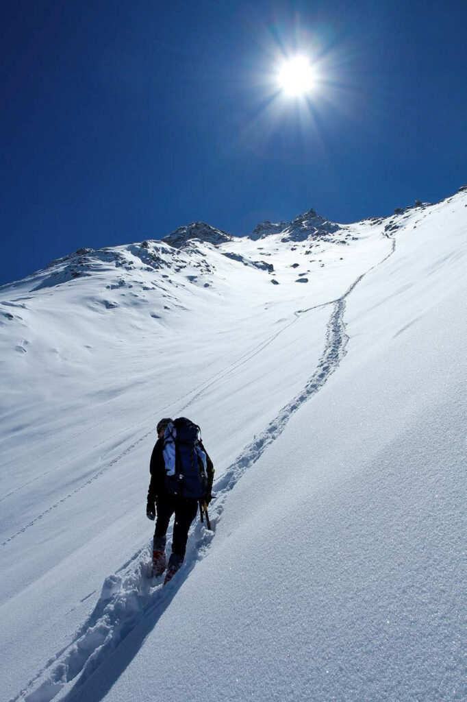 Hiker persevering up a mountain
